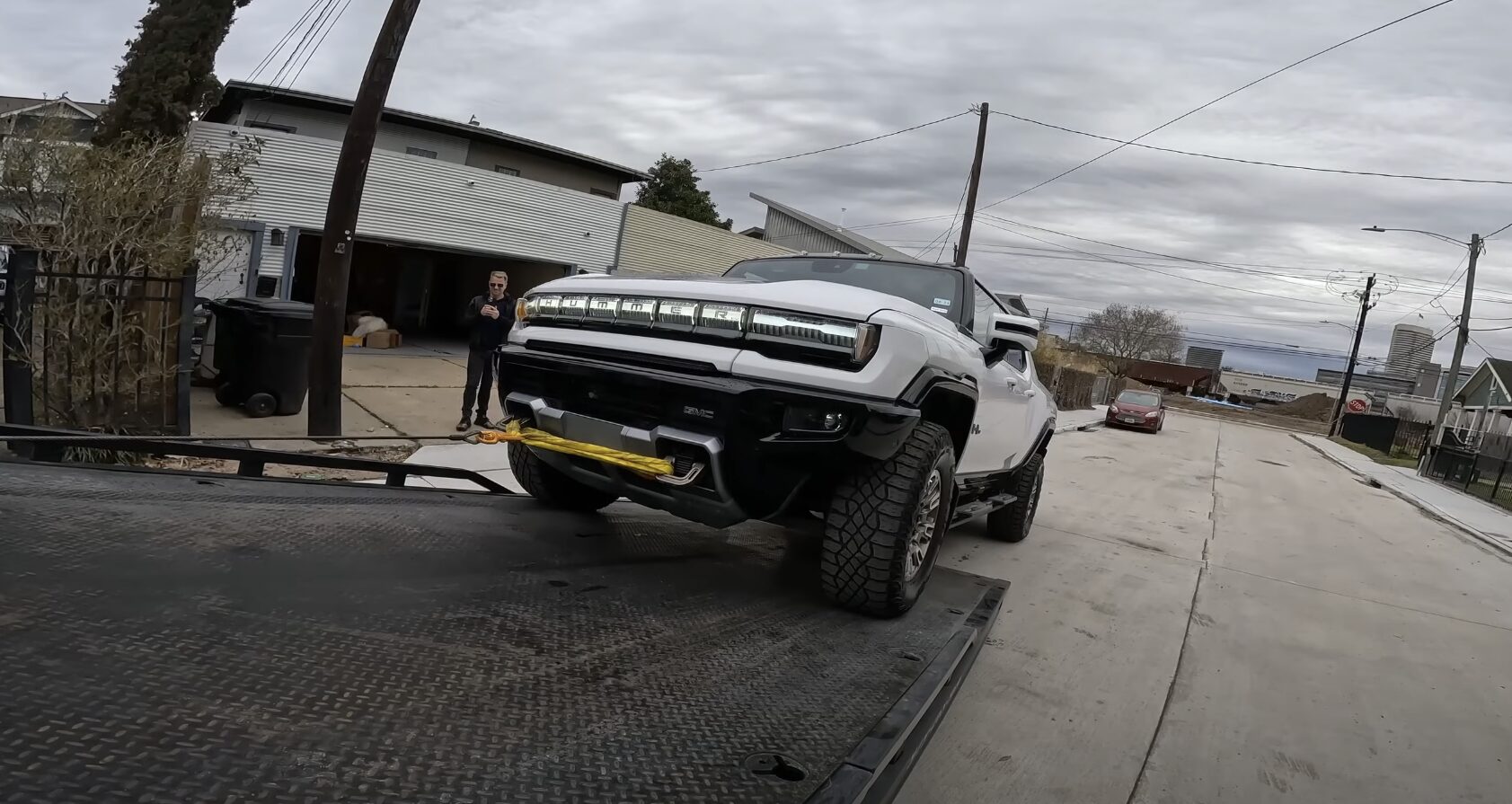 Professional Vehicle Towing - Protecting Your Investment Professional tow truck loading a white pickup truck